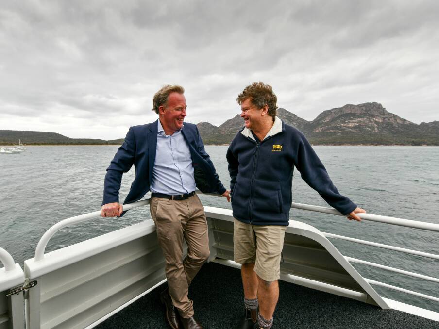 CRUISING: Premier Will Hodgman with Rob Pennicott on board the businesses latest offering - a cruise in the Freycinet Penninsula. Picture: Scott Gelston