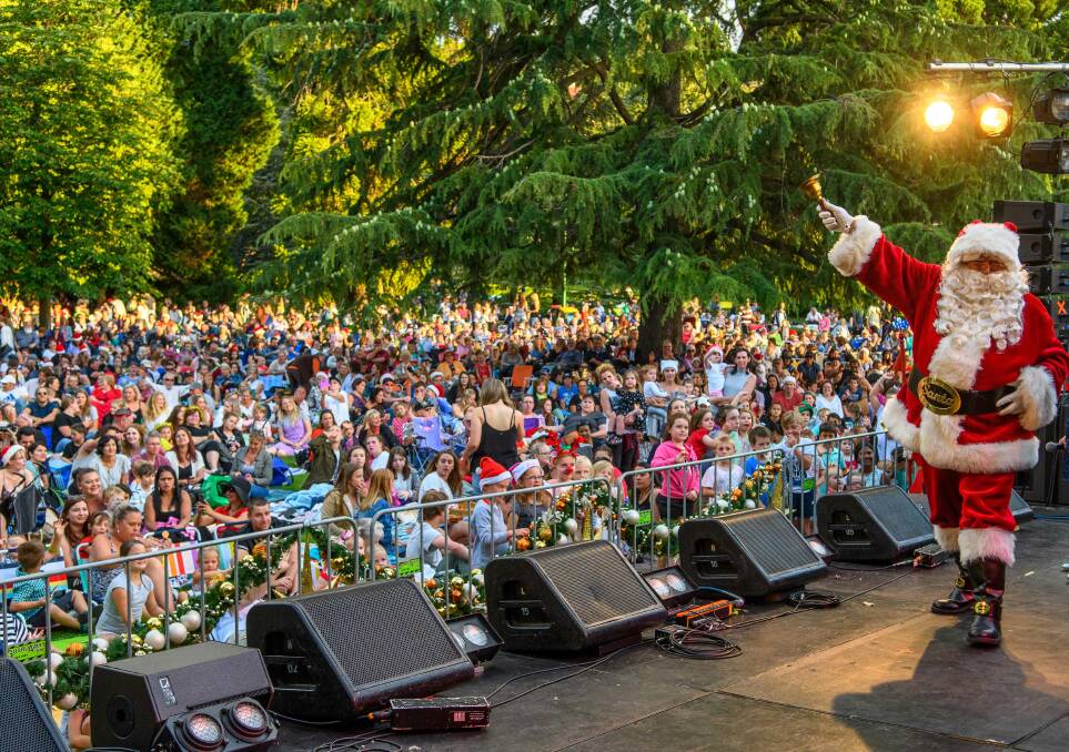 HERE COMES SANTA CLAUS: The crowd watching Santa on stage at last year's Carols by Candlelight event. Picture: Scott Gelston