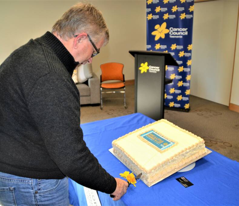 RECOGNISED: One of Launceston's first Transport to Treatment volunteers, Jim Fletcher, cuts the cake at the volunteer morning tea. Picture: Kasey Wilkins