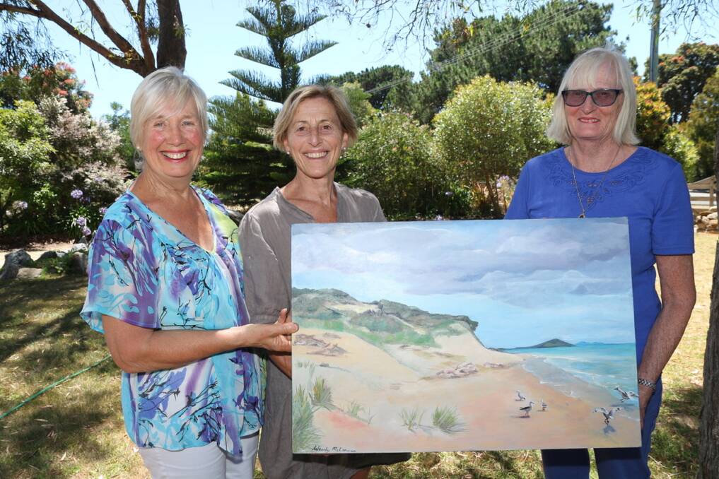 ARTISTIC ENDEAVOURS: Left to right, Wendy McLennan, Rose Wilkinson, and Ruth Timperon with McLennan's painting of the Tomahawk sand dunes at the Brushstrokes Art Exhibition. Picture: supplied