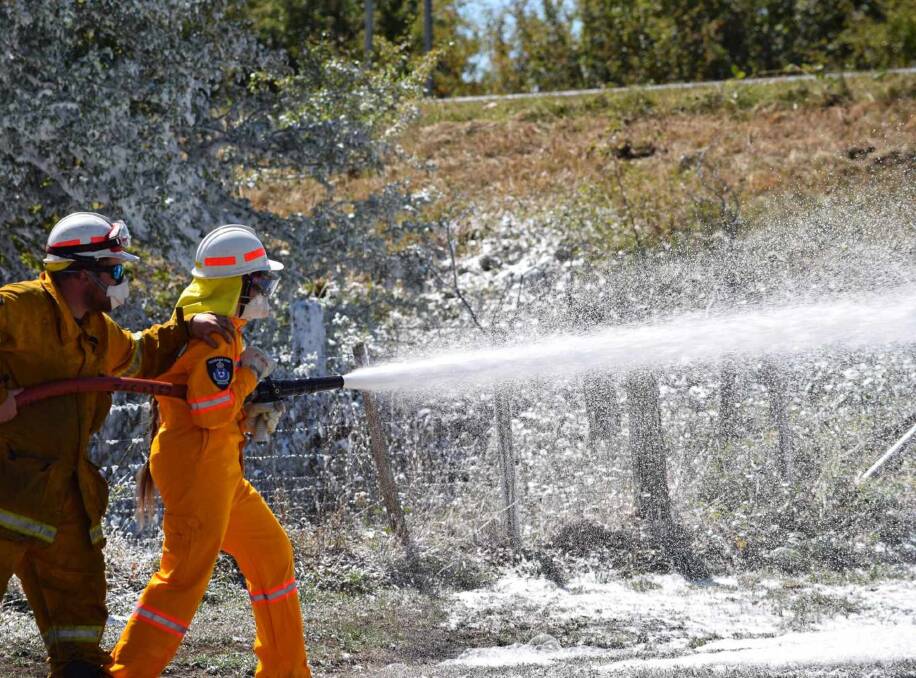 TRAIN: Catherine Bean takes part in a training session in using a compressed air foam system with the Fingal Fire Brigade. Picture: supplied