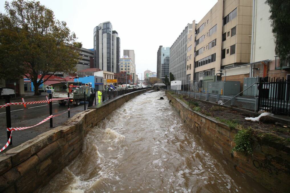 OVERFLOWING: The Hobart rivulet during the severe weather. Picture: Monte Bovill