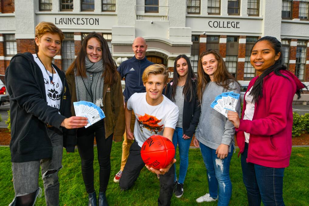 FOOTY: Hawthorn state manager David Cox with Swiss and Brazilian exchange students at Launceston College. Picture: Scott Gelston