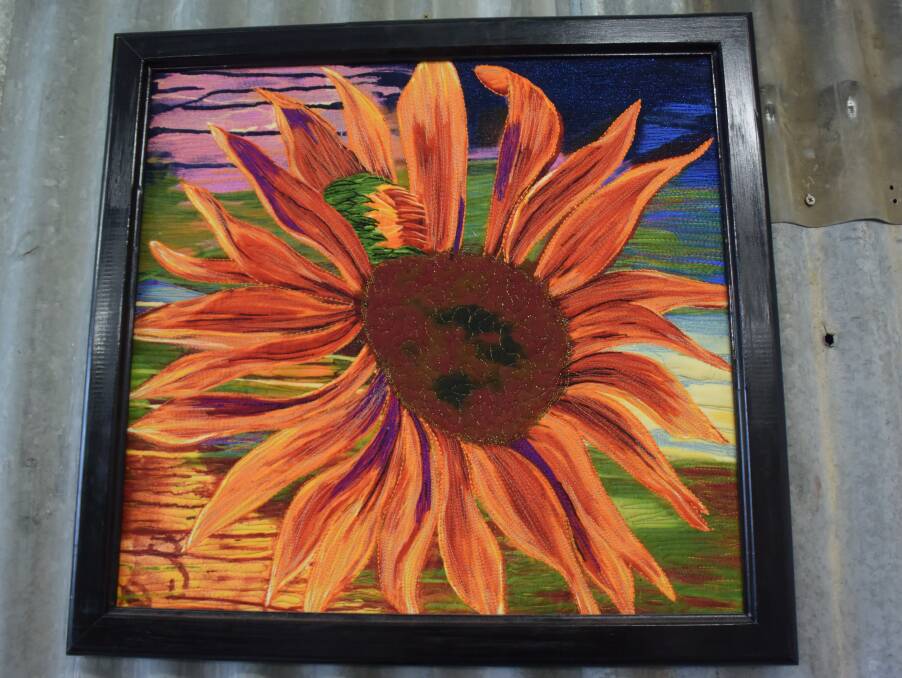 A sunflower embroidered by one of Mrs Johnson's machines at her Beaconsfield home. The picture now hangs on her workshop wall.