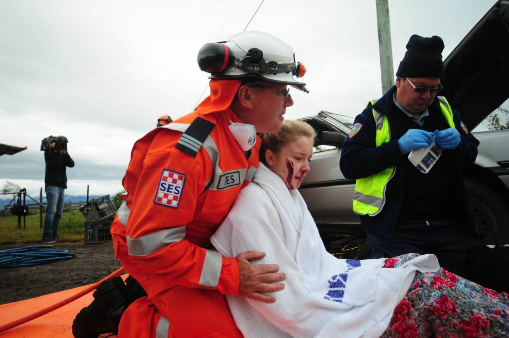 SES volunteer Colin Perkins comforts road crash victim" Mikayla Fulton at an SES, police, fire brigade and ambulance exercise at Cressy in 2013. 