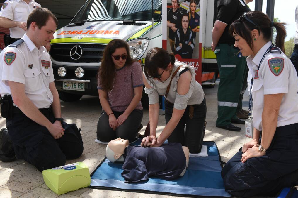 Tas Ambulance paramedic intern Corey Armstrong, with paramedic Jill Finn show Melanie Tulisi and Melissa Sheridan show use an AED to save a life using CPR. 