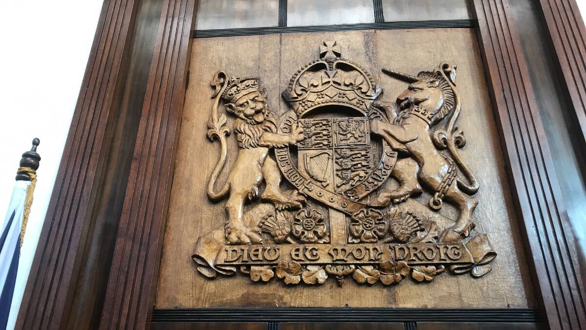 WOODCARVING: World renowned artist Nora Payne's coat of arms in Tasmania's House of Assembly. Mrs Payne also has work in St Andrew's Church at Westbury. Picture: Supplied.
