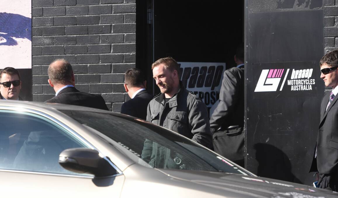 CHARGED: Launceston Braaap Wholesale Pty Ltd general manager Toby Wilkin leaves the store in the company of detectives from NSW and Tasmania on Wednesday morning. Picture: Scott Gelston