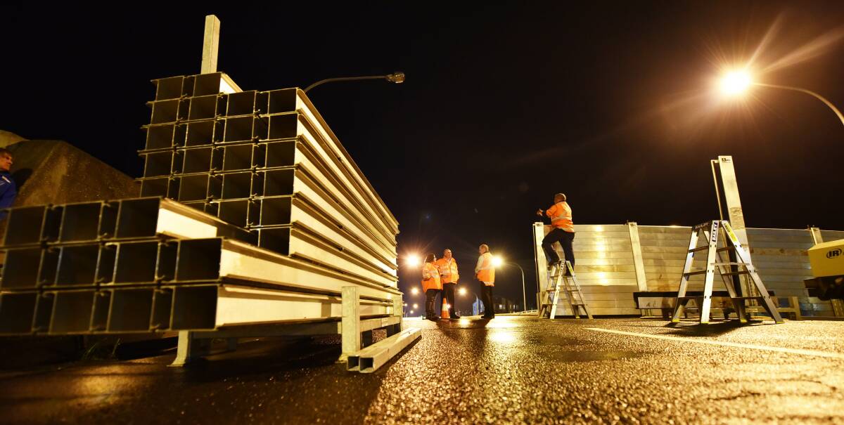 READY: Launceston City Council crews prepare the northern Charles Street floodgate on Tuesday night. Picture: Scott Gelston
