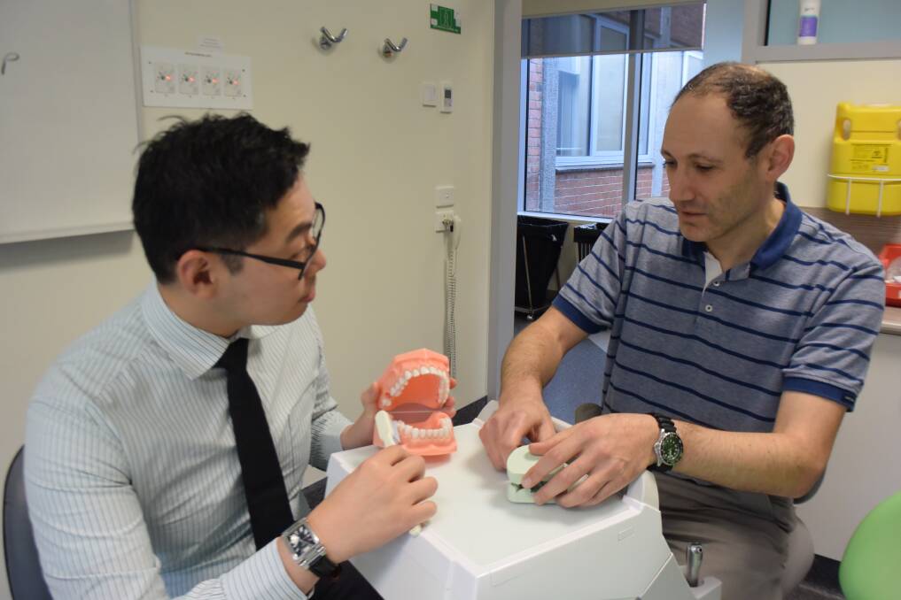 IN TRAINING: GPTT registrar Boon Sie learning some dentistry skills from dentist Dr Richard Annis during the GPTT dental workshop at Northern Dental Health Centre on Tuesday. Picture: Carly Dolan