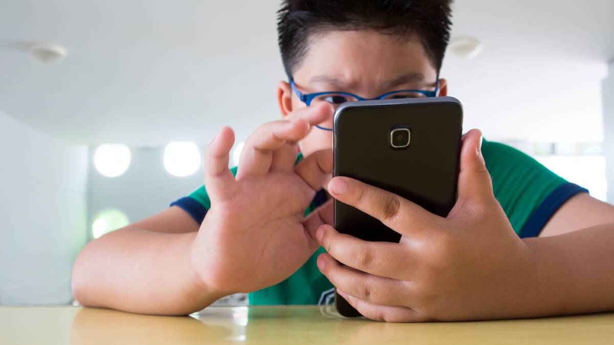 Let us be: A file picture of a teen using a mobile phone. Chloe Hawkins says removing a phone won't help an issues teens face. Picture: Shutterstock