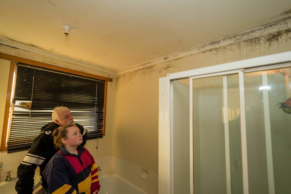 David and Taylor Kearnes inspect the mould that has spread around the bathroom of their Housing Tasmania house in Trevallyn, which reappears regularly despite their best efforts. Picture: Phillip Biggs