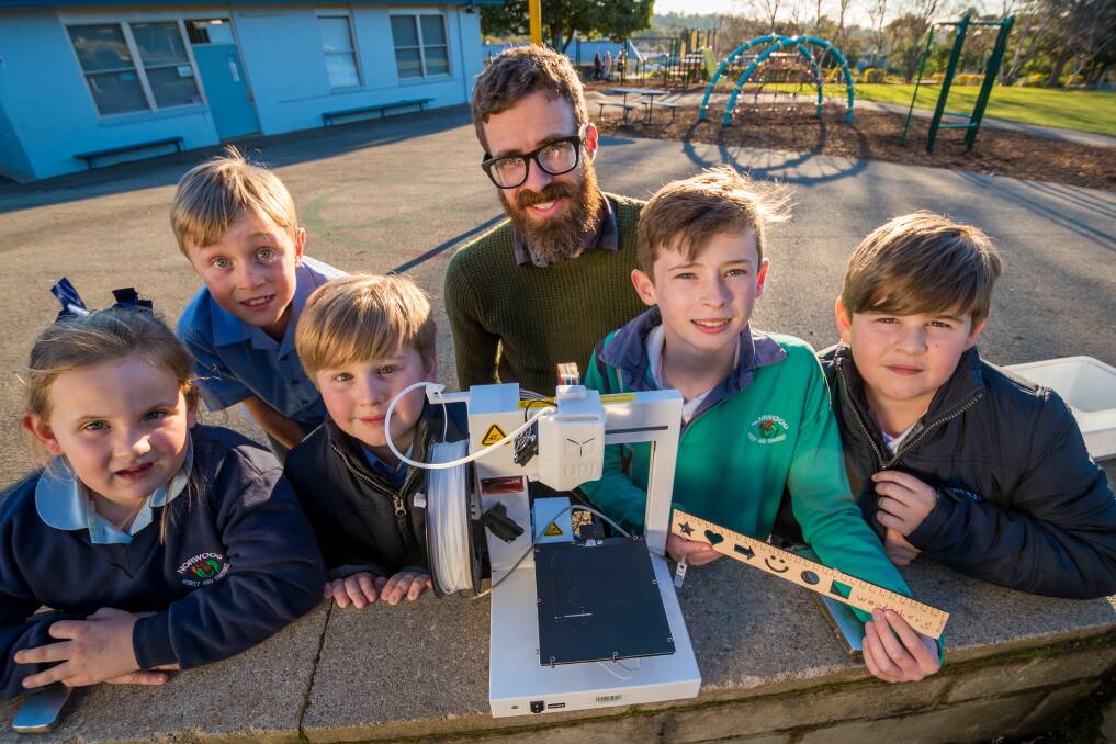 Norwood Primary School students Maya Innes, Levi Merritt, Charlie Cunningham, Levi Swift and Alex Cunningham with parent Andrew Swift with the 3D printer purchased thanks to last year's fair. Picture: Phillip Biggs