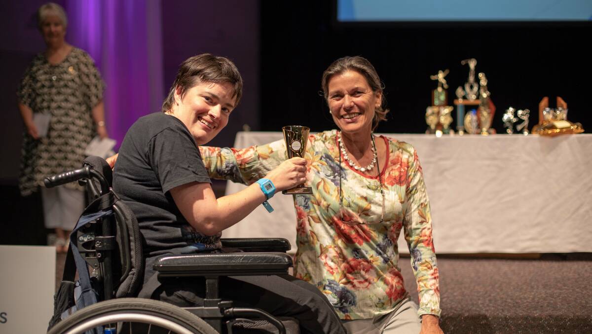 New Horizons athlete Minna Blaney receives a trophy from Saskia Ascui at the awards night last week. Picture: supplied