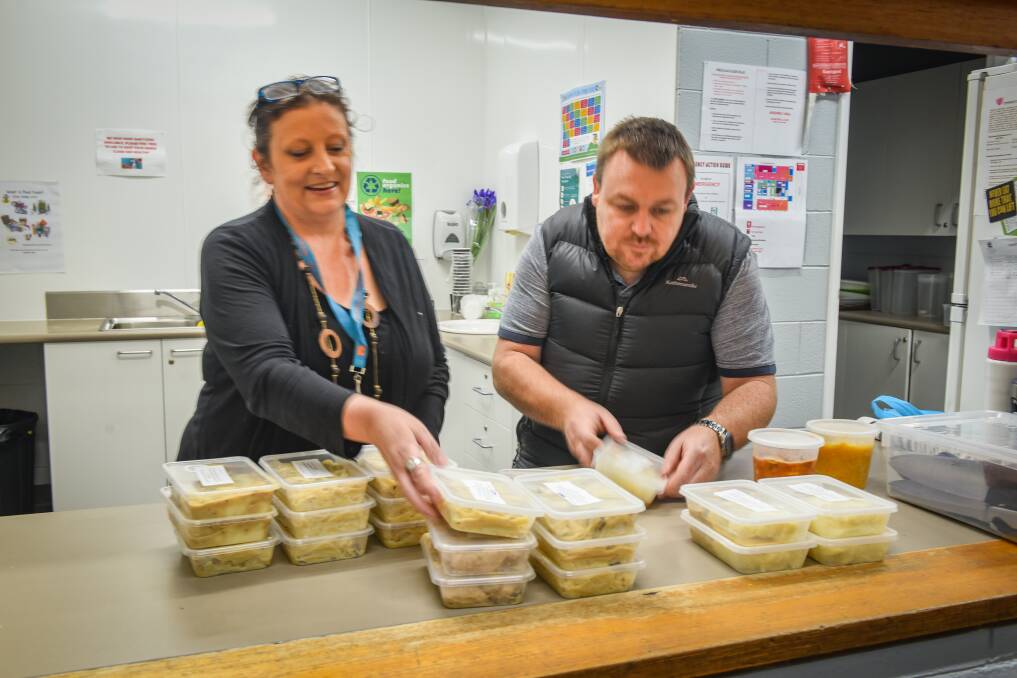 Julie Moy and Rick Mansfield finish off the freezer fillers in Ravenswood. On Wednesday, they prepared chicken fettuccine. Picture: Paul Scambler
