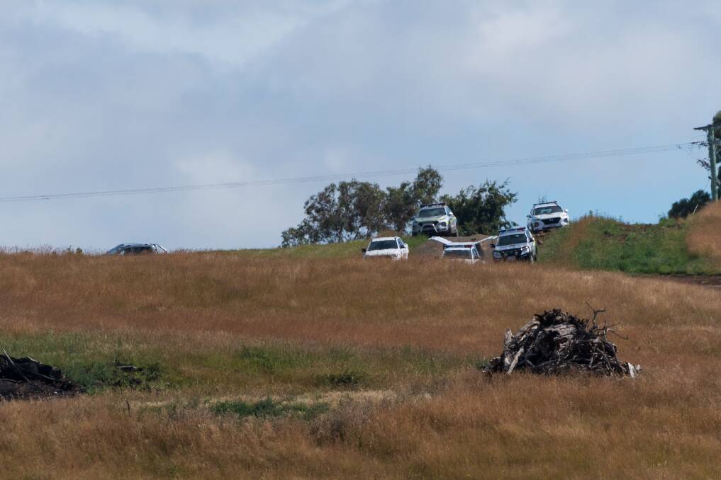 Police cars on the scene of a fatal vehicle rollover at Exton. Picture: Phillip Biggs