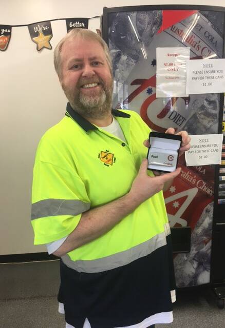 Paul with his badge celebrating 15 years of service to Coles. Picture: Supplied