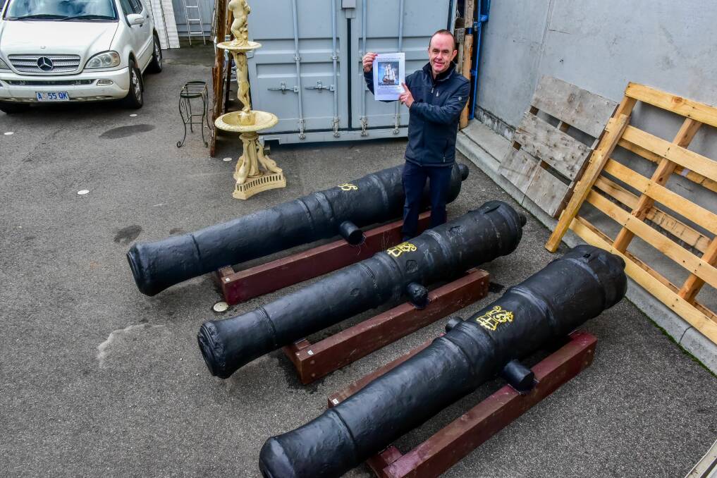 Auctioneer Neil O'Brien with the three cannons from HMS Colossus to be auctioned in Launceston on Wednesday. Picture: Neil Richardson