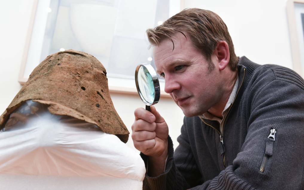 QVMAG curator of history Jon Addison inspects a convict hat found with a range of artefacts during a dig at the Kings Meadows Convict Station. Picture: Neil Richardson