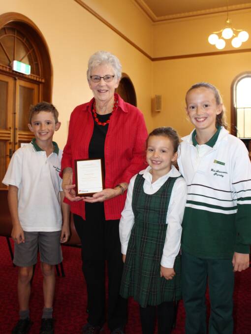 Margaret Duggan with her volunteer award for Girl Guides, with Joshua, Annaliese and Caitlin Douglas.