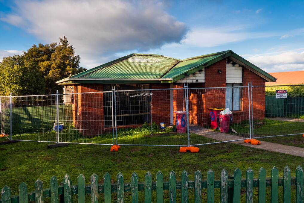 The house has been fenced off in preparation for demolition works. Picture: Phillip Biggs