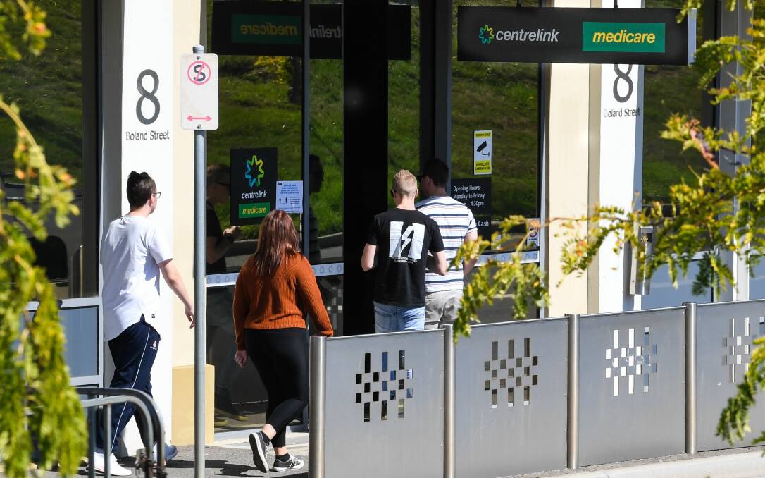 Newly unemployed people line up at Centrelink in Launceston in March as the COVID crisis resulted in mass job losses.