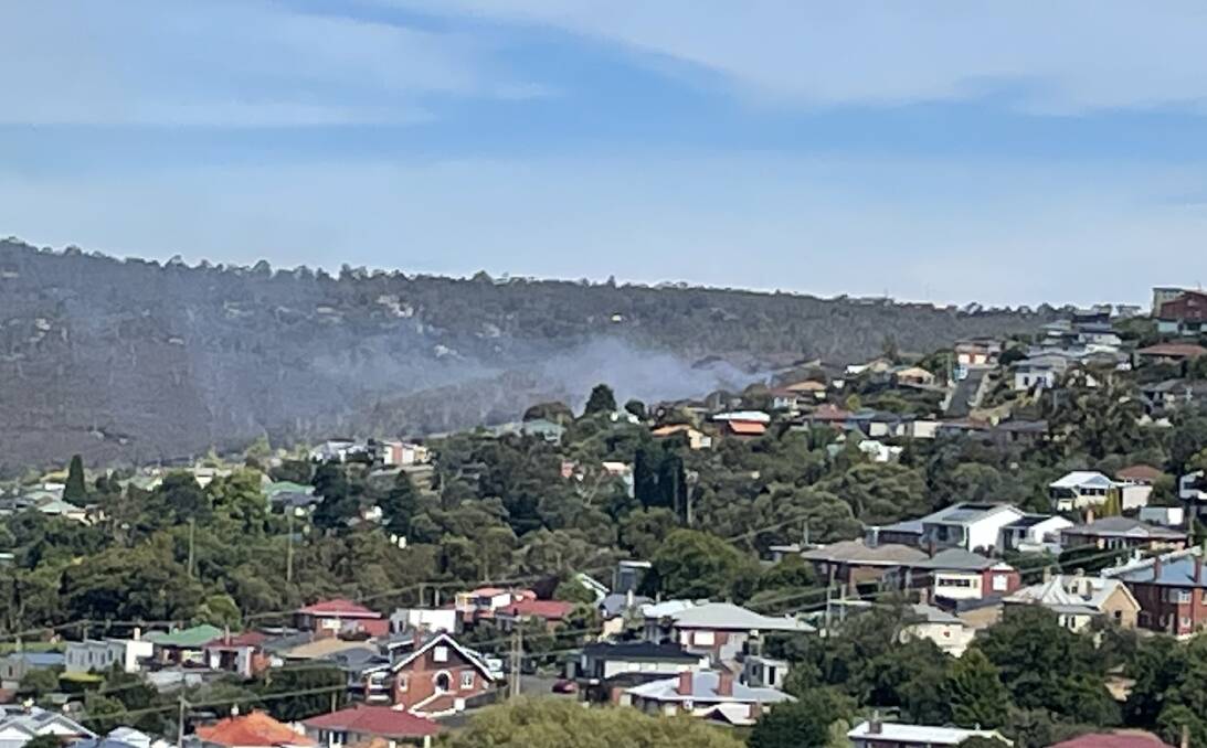 Smoke could be seen near homes in southern Hobart on Saturday, prompting a rapid response from the TFS. A cause has been determined. Picture: Adam Holmes