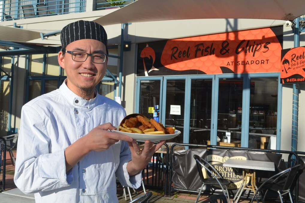 Restauranteur, and now fry cook, Lei Wang displays some of the seafood offerings at Reel Fish and Chips, formerly Youjing Chinese Restaurant. Picture: Adam Holmes
