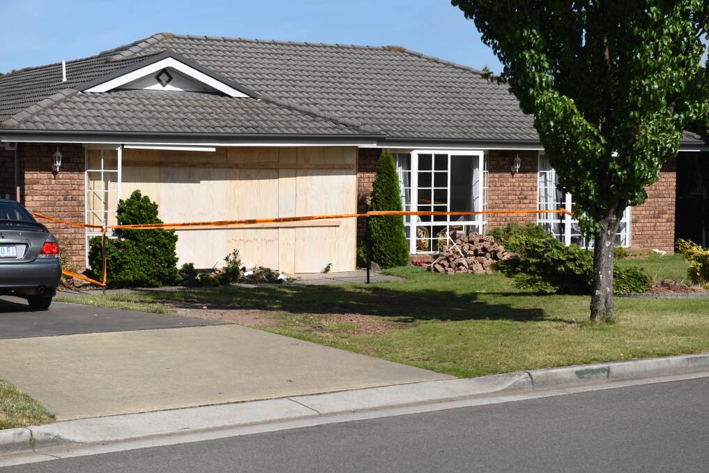 The house on Cheltenham Way, Prospect Vale, had been boarded up by the next day. The Supreme Court heard $150,000 damage was caused. Picture: Paul Scambler