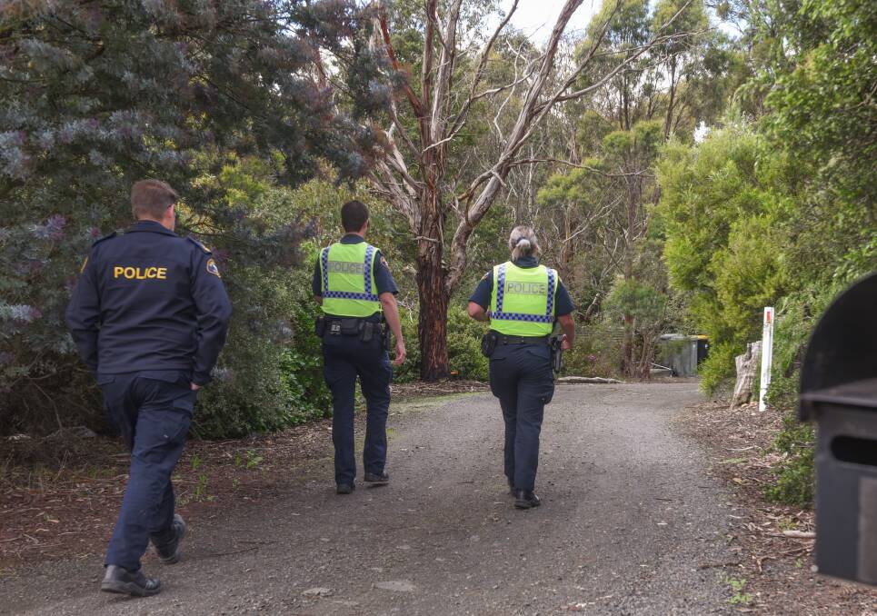 Tasmania Police arrive at the address in Devon Hills to help negotiate after a standoff started between residents and a bailiff who was attempting to evict them. Picture: Paul Scambler