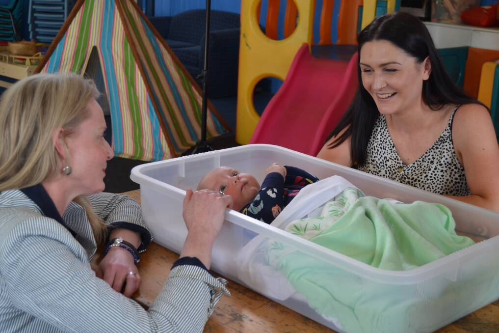 SAFE: Health Minister Sarah Courtney with Ashleigh Smith and baby Ollie at Playgroup Tasmania in Invermay on Sunday. Picture: Adam Holmes