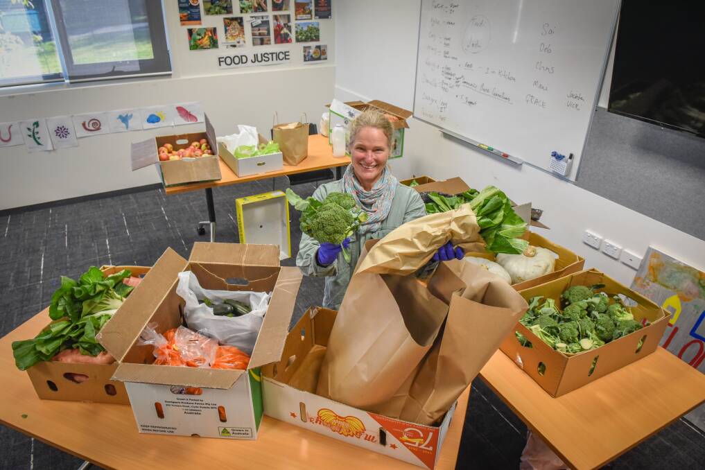 Jo Dean puts together parcels of fresh fruit and vegetables at the Northern Suburbs Community Centre. Picture: Paul Scambler