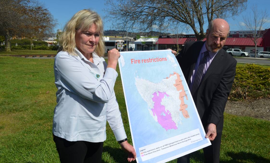 TFS acting deputy chief Sandy Whight and Police, Fire and Emergency Management Minister Mark Shelton with the fire restrictions map. Picture: Adam Holmes