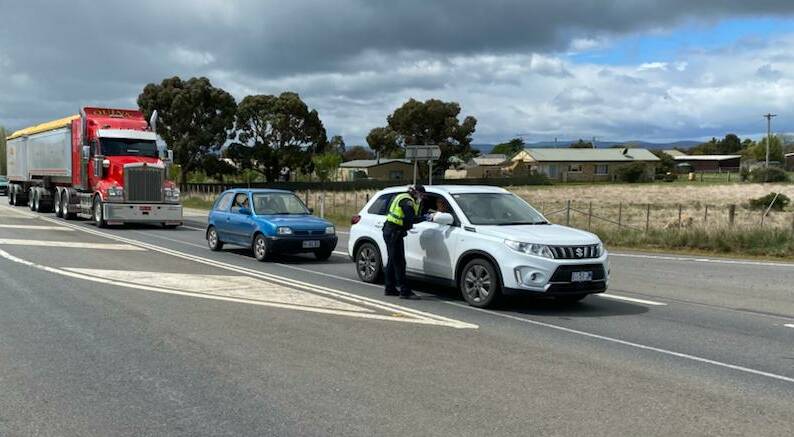 Police established checkpoints at four major arterial roads heading out of the lockdown area which included 12 council areas, checking for reasons for travel. Picture: Tasmania Police