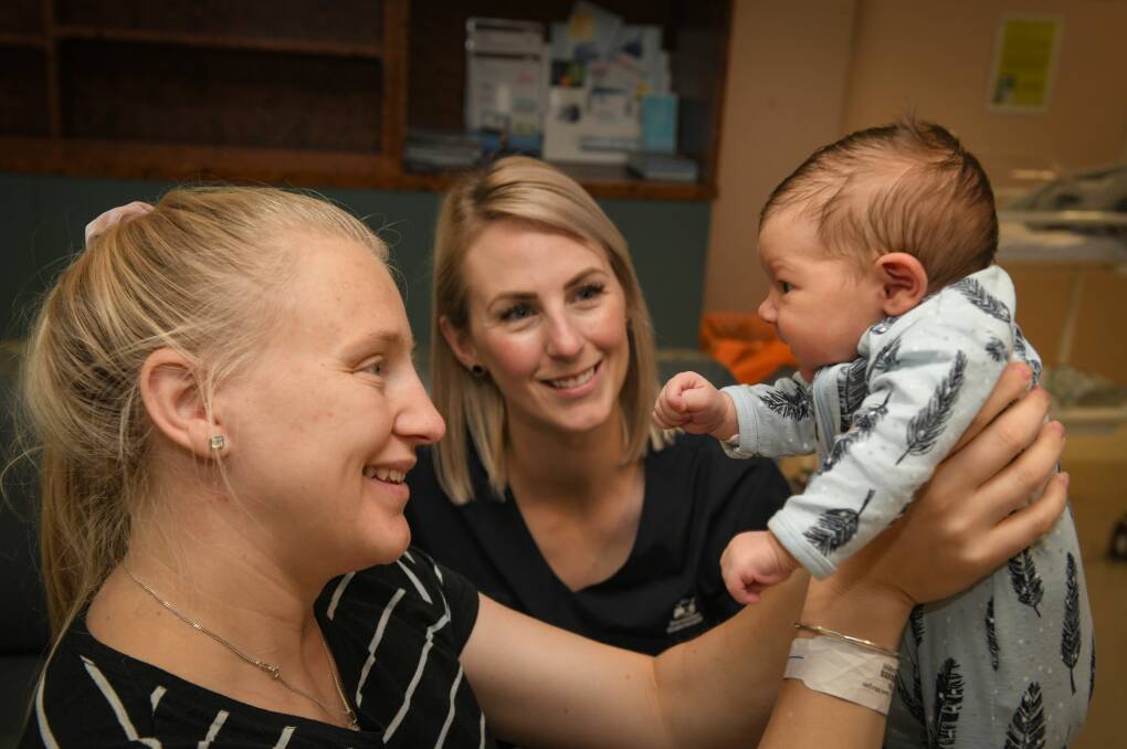 Ashli Thornhill holds baby Archer Eli, with LGH midwife Stacey Pendrey. Picture: Paul Scambler