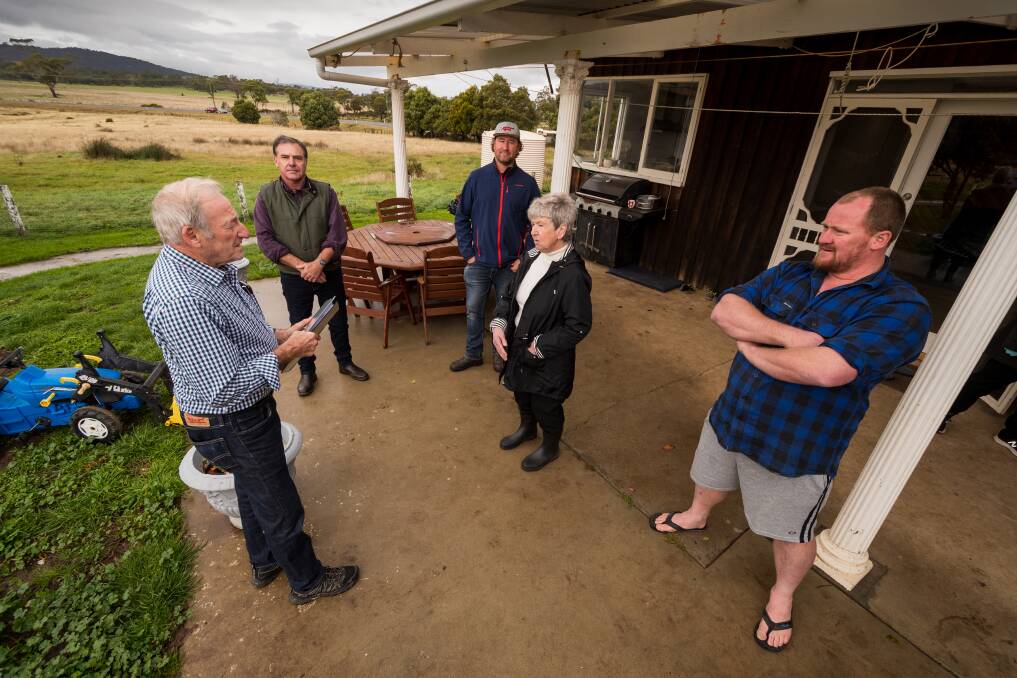 Ivan Dean MLC discusses the issue with nearby residents on Saturday. Picture: Phillip Biggs