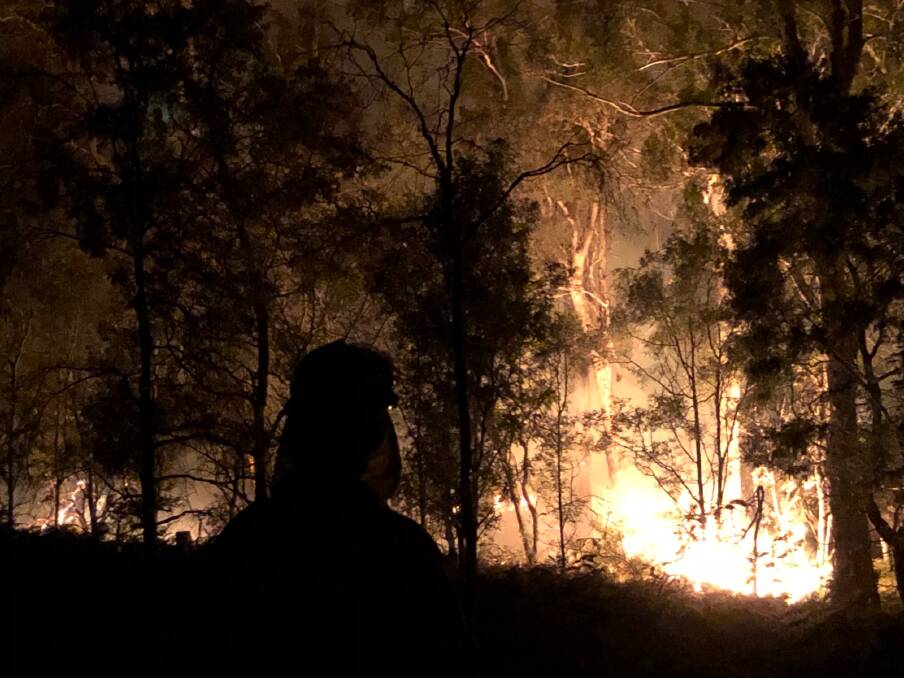 Night duty brigades fight the fire at Mount Malcolm, to the south-east of Fingal, burning towards the Douglas-Apsley National Park. Picture: Andrew Taylor