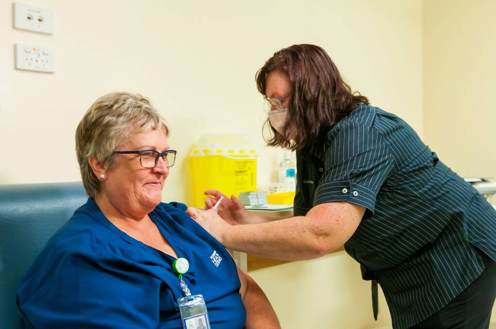 Acute medical unit nurse manager Robyn Hayes recieves the first COVID-19 vaccination at Launceston General Hospital from vaccine clinic team leader Robyn Morey in March. Picture: Phillip Biggs
