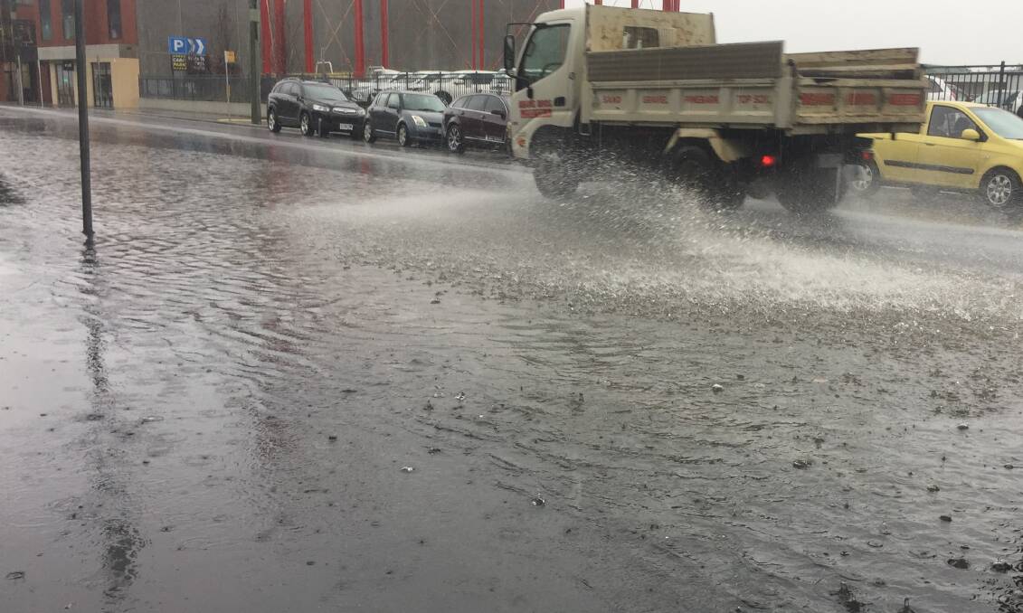 Cimitiere Street appears to be struggling to cope with this morning's rain. Picture: Adam Holmes