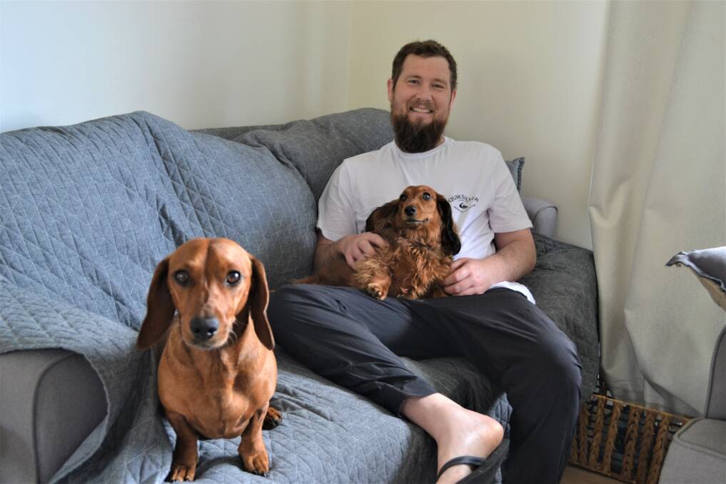 Daniel at home with Murph and Millie. Picture: Adam Holmes