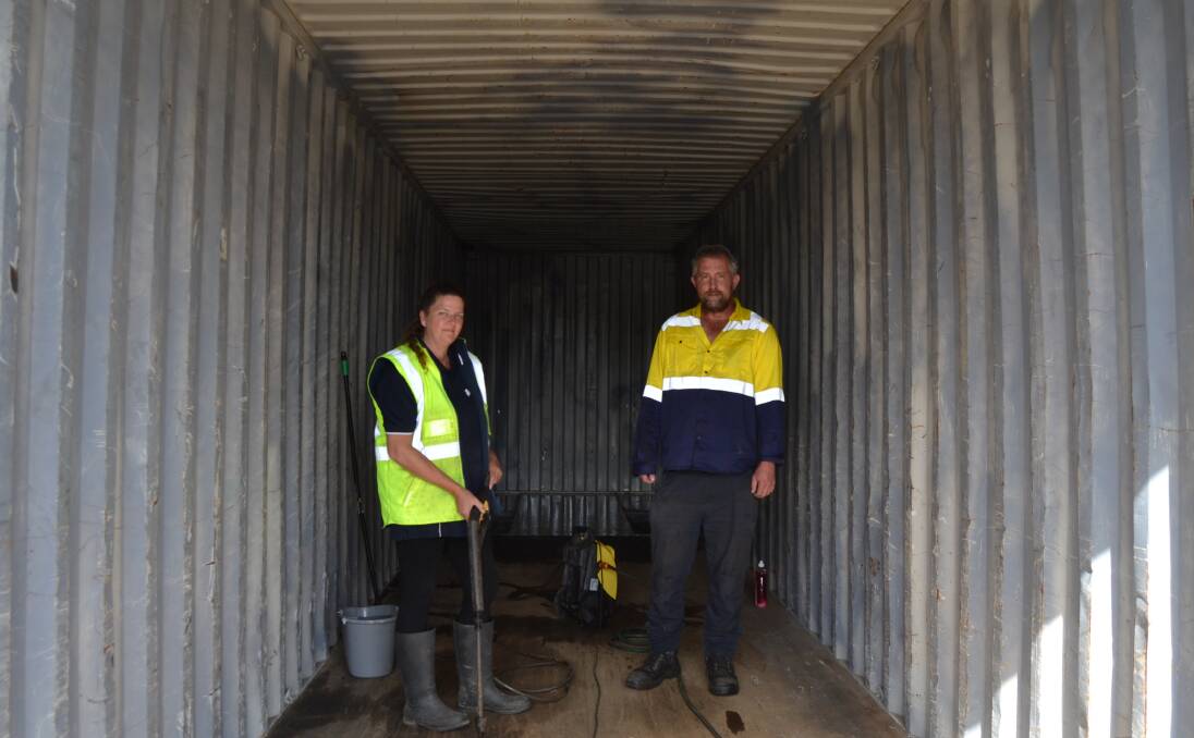 Strike It Out Inc founder Kirsten Ritchie and volunteer Craig Boyd-Jones clean the shipping containers in preparation for installing sleeping pods to help the homeless in Launceston. Picture: Adam Holmes