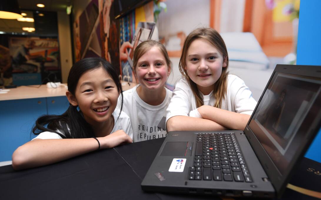 WINNERS: Claire Lau, 11, Sophia Gianotti, 11, and Angelica Talevi, 9, of St Philip Neri School in Northbridge, were named national winners of the primary school category for their app Reading Republic. 