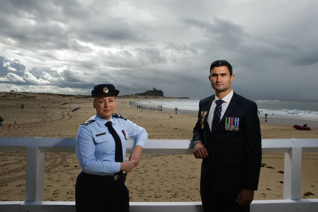 Proud Day: Anzac Day has deep meaning for RAAF corporal Rebecca Roach and Australian Army captain Doyle Beaudequin, pictured at Nobbys beach. Picture: Jonathan Carroll 