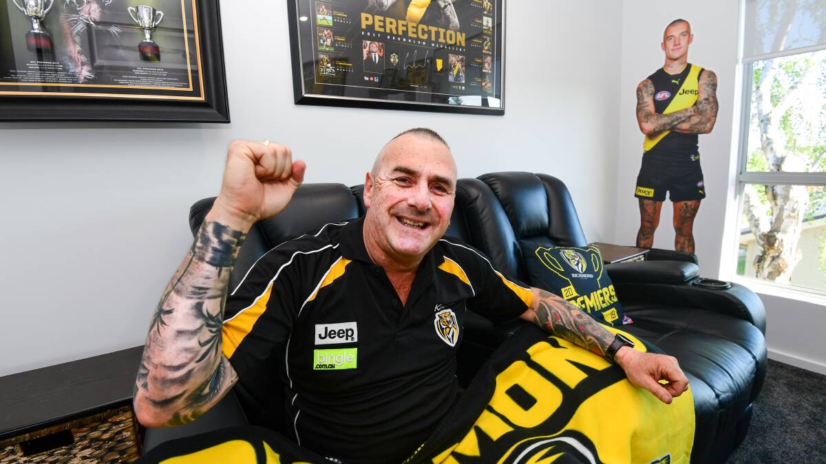 Fandom: Matthew Brooks in his 'Dusty room' with the man himself: Dustin Martin behind him. Picture: Neil Richardson