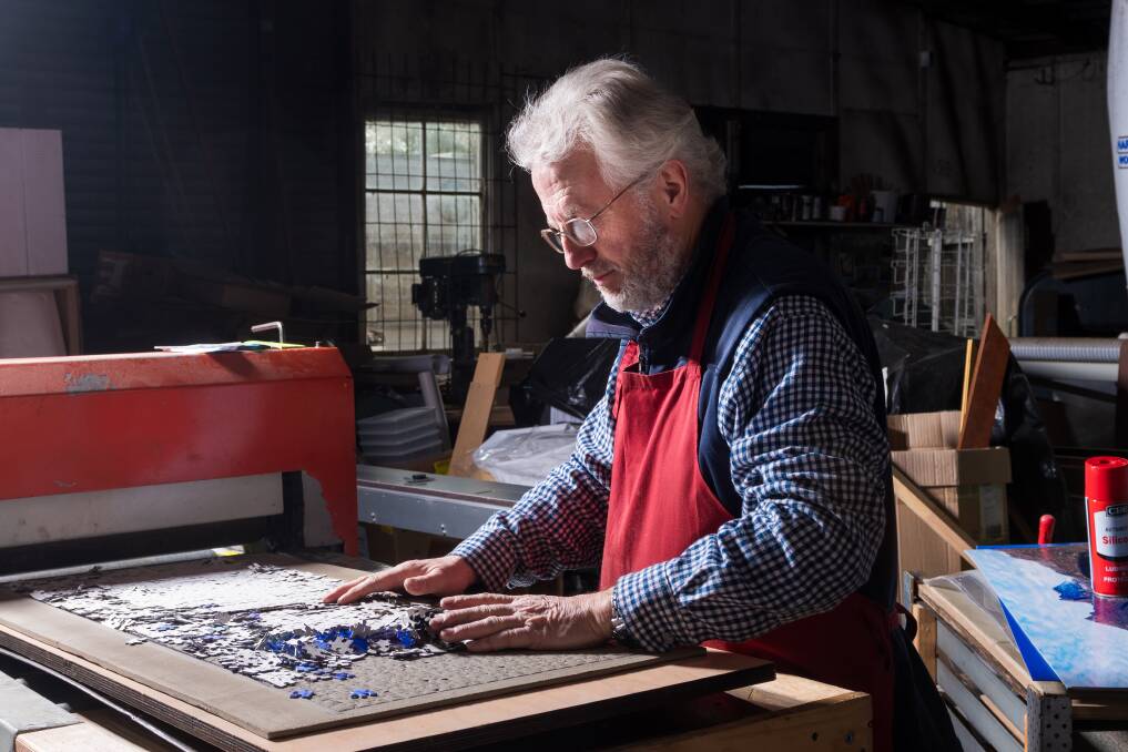 Assembly required: Westbury photographer and puzzle maker John Temple has a cutter to produce 1000-piece jigsaws. Picture: Phillip Biggs