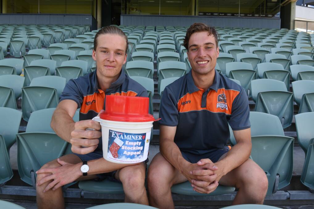 Just good cricket: Greater Northern Raiders James Beattie and Ollie Wood rattling The Examiner Empty Stocking fund tin at UTAS Stadium. Picture: Paul Scambler