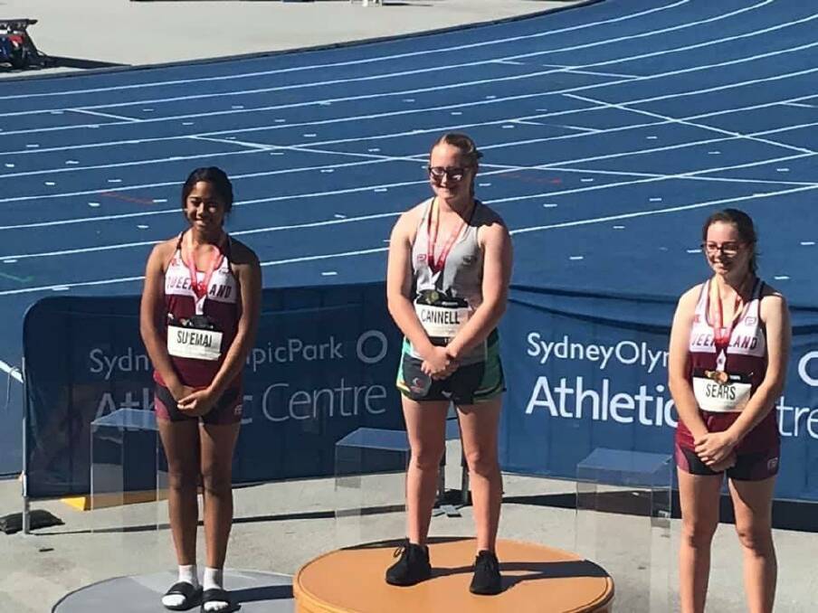 CHAMP: Arielle Cannell atop the podium for one of her hammer throw wins. Picture: supplied