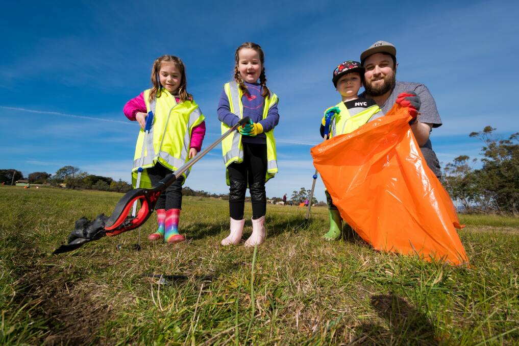Green machines: Clean Up Local organiser Marcus Ling with Alice Broad, Harper Ling and Ash Ling, beside Lilydale Road, Rocherlea. Pictures: Phillip Biggs