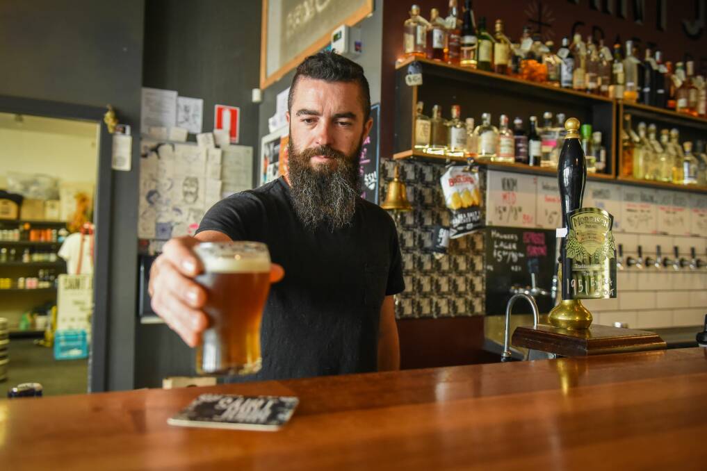 Cheers: Saint John Craft Beer bartender Kilty Salter pours a cold beer on a hot Launceston day. Pictures: Paul Scambler