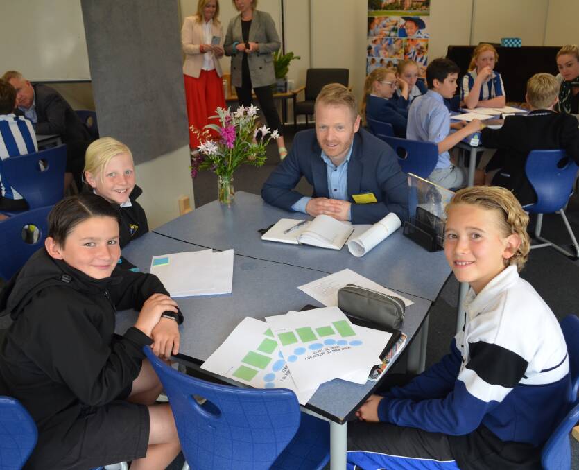 INNOVATE: Grade 4 pupils Oliver Carswell, Lachie Hirst, Saxon Baldock pitch their ideas on new entertainment events in Launceston to Cityprom's Steve Henty. Picture: Harry Murtough.
